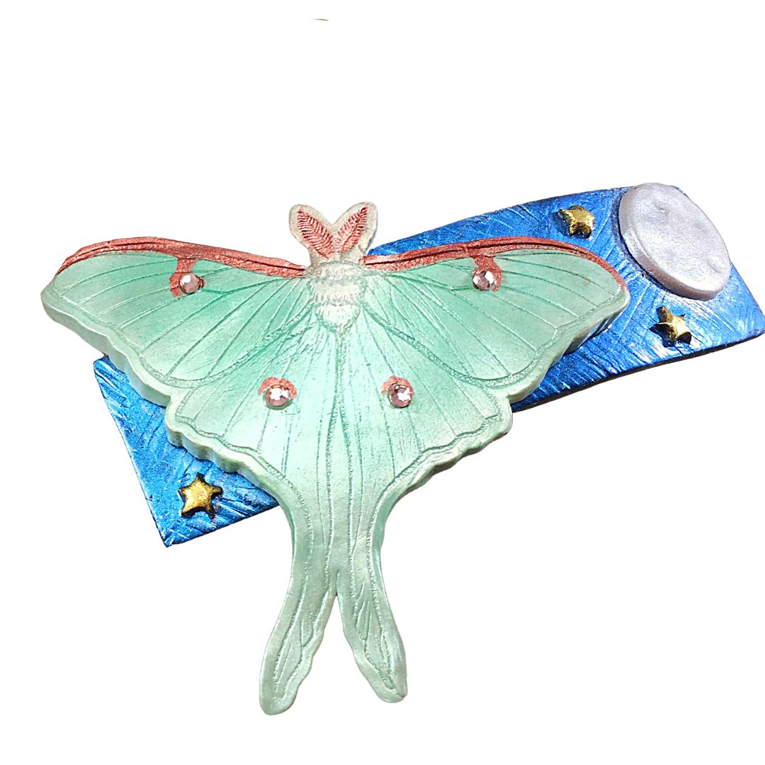 Polymer clay green giant silk moth on blue base with moon and stars hair clip.