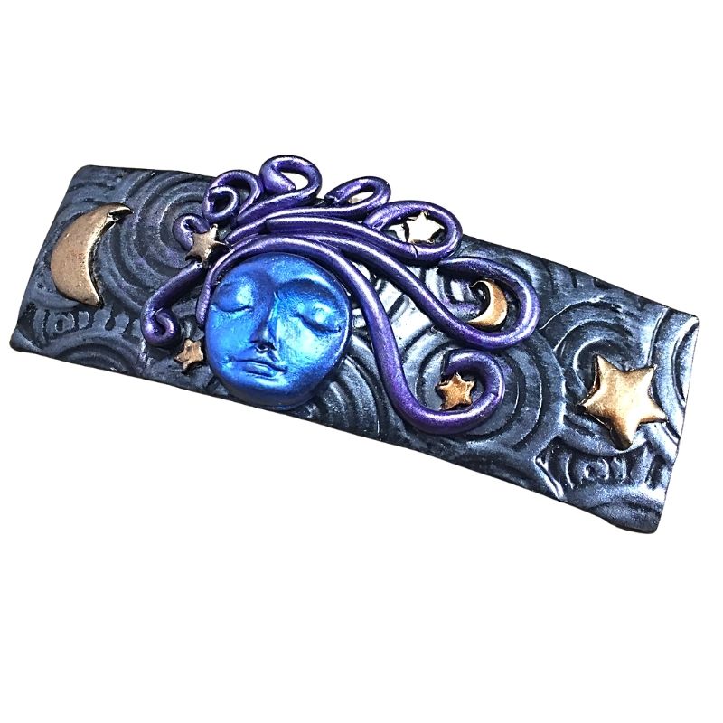goddess of the moon hair clip with blue face and purple hair and gold moon and stars