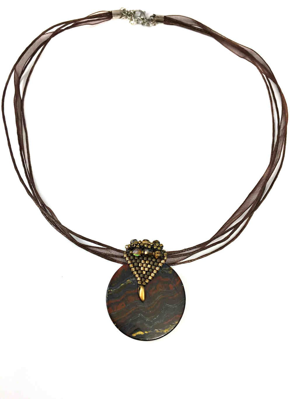 elegant tigers eye pendant with elaborate beaded gold bail