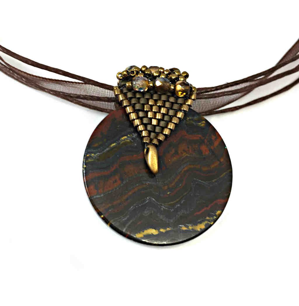 elegant tigers eye pendant with elaborate beaded gold bail