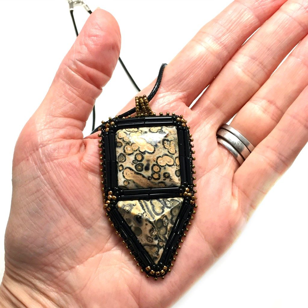 leopardskin jasper pendant in hand