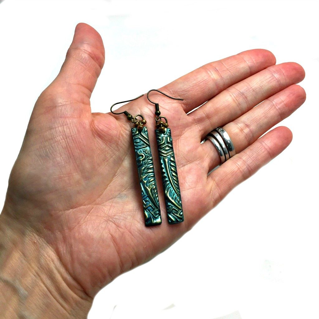 green zentangle earrings in hand