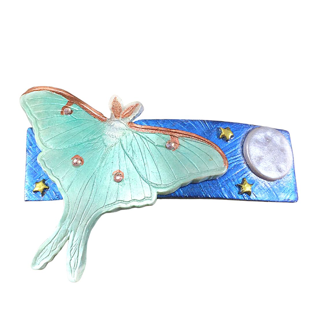 Polymer clay green giant silk moth on blue base with moon and stars hair clip.