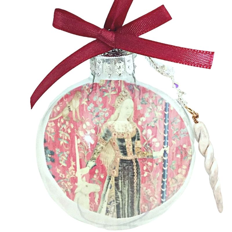 medieval woman with unicorn graphic in christmas ball ornament with red ribbon and unicorn horn charm