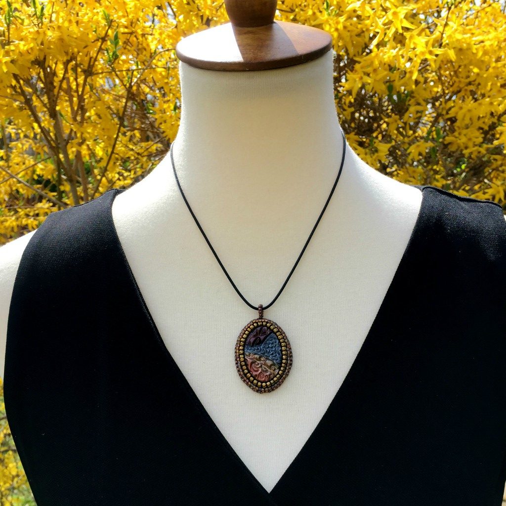 metallic zen tangle pendant on mannequin