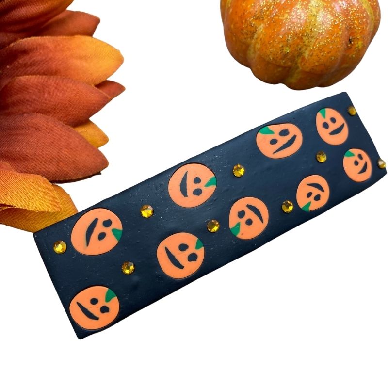 orange pumpkin hair barrette on black clay with orange crystals