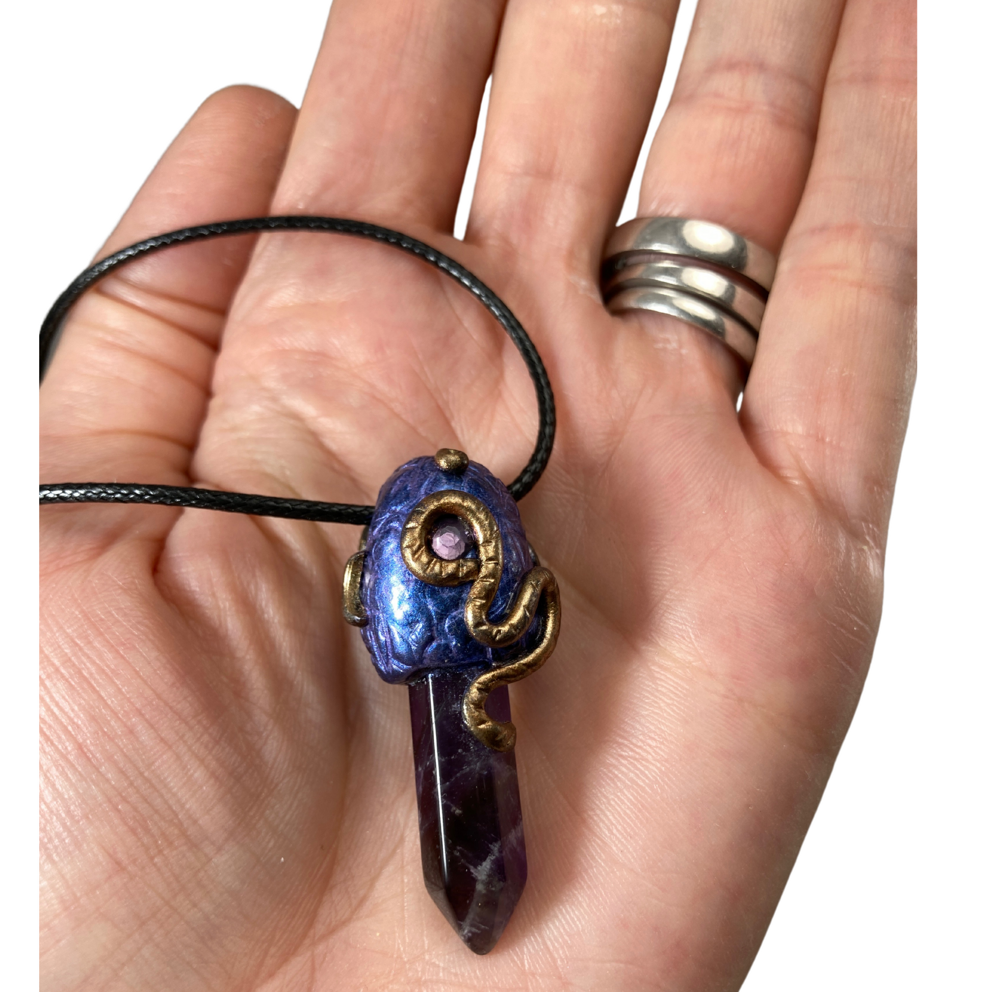Amethyst Crystal point necklace with purple polymer clay bail with snake design in hand