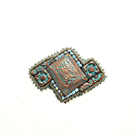 front view of copper patina brooch