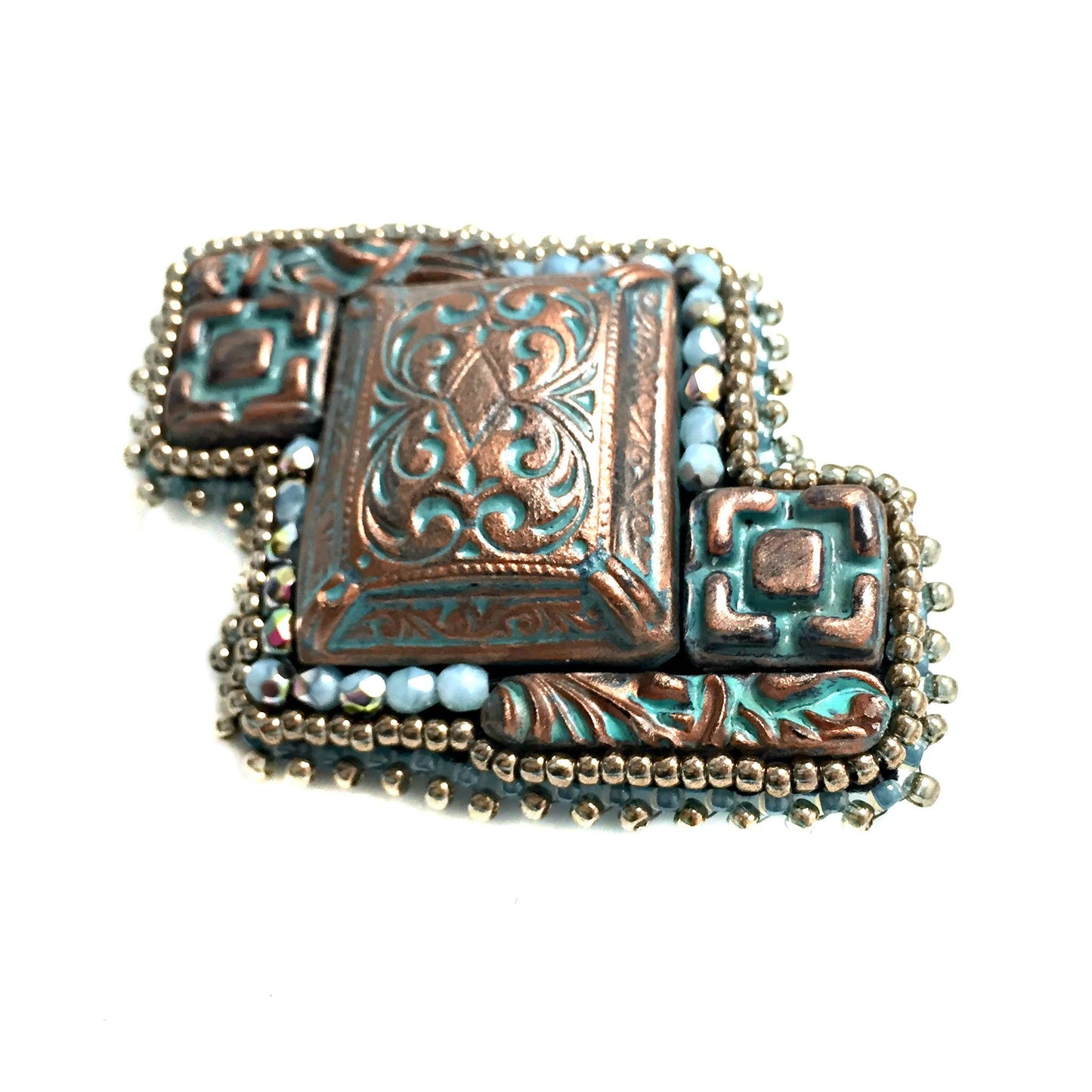 side view of copper patina brooch