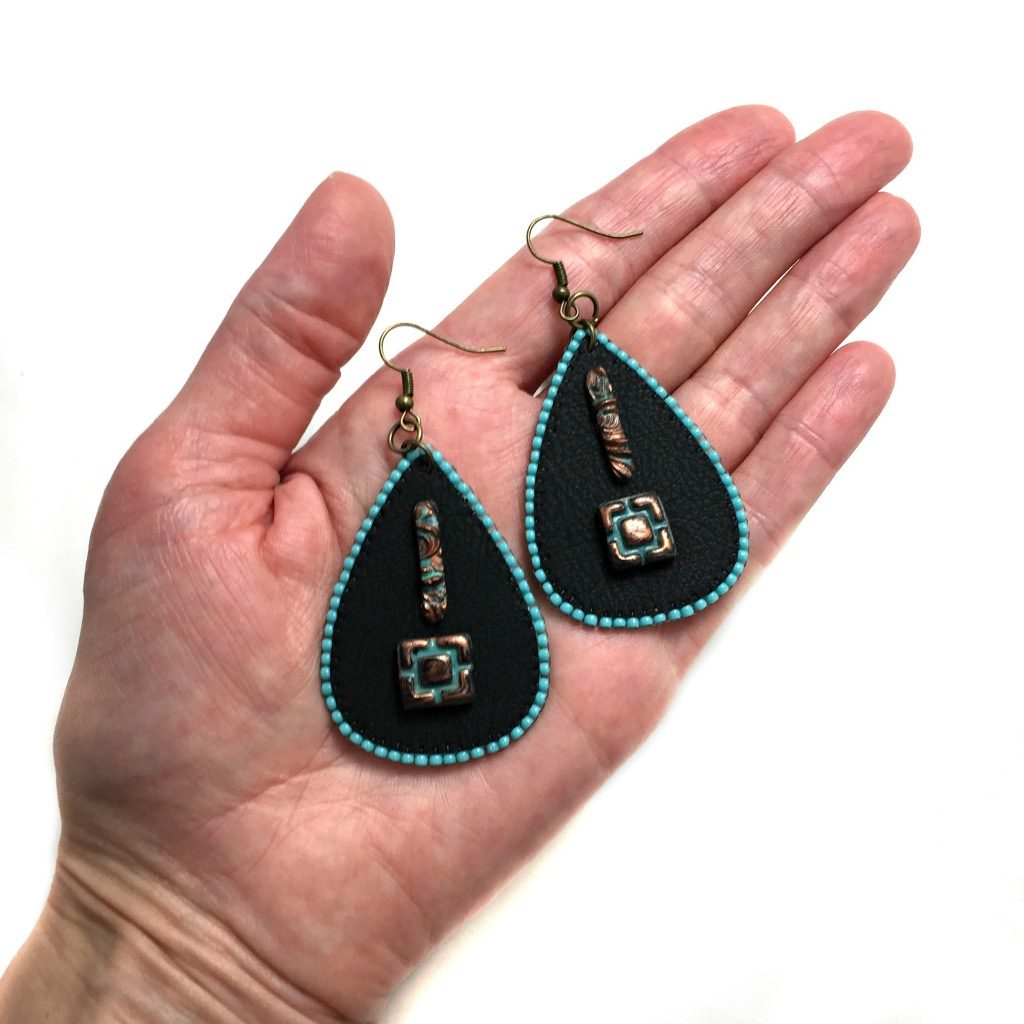 rustic faux leather earrings in hand