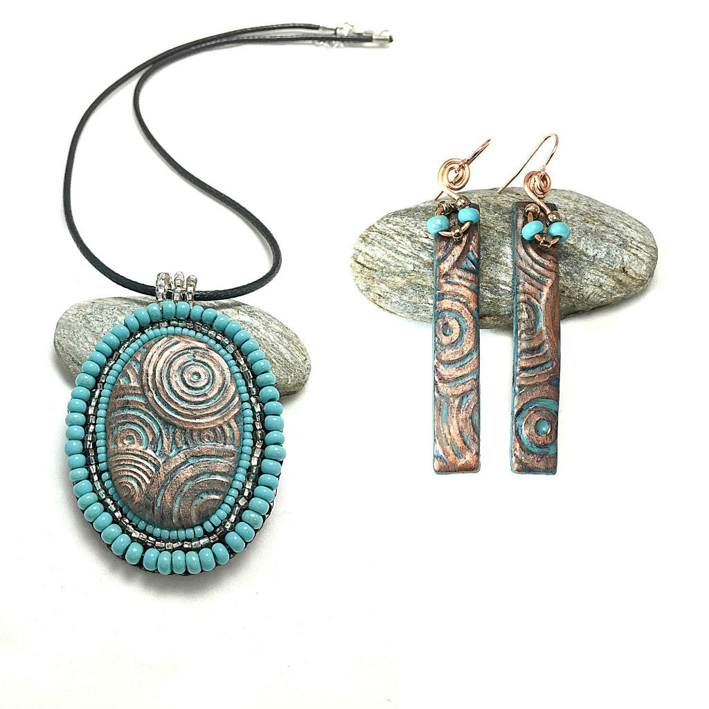 Oval Patina pendant with circle texture and turquoise and silver beading with matching bar earrings.