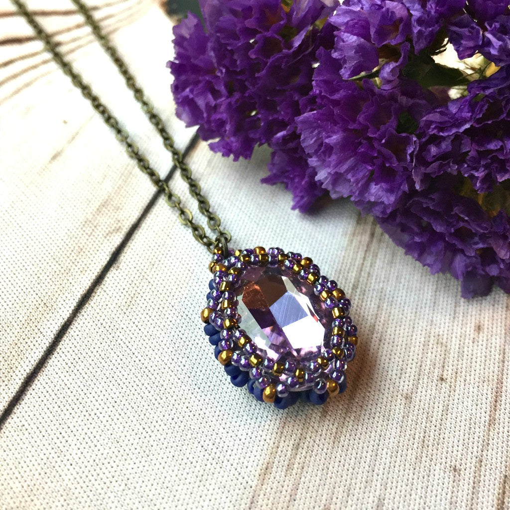 side view of purple amethyst crystal necklace