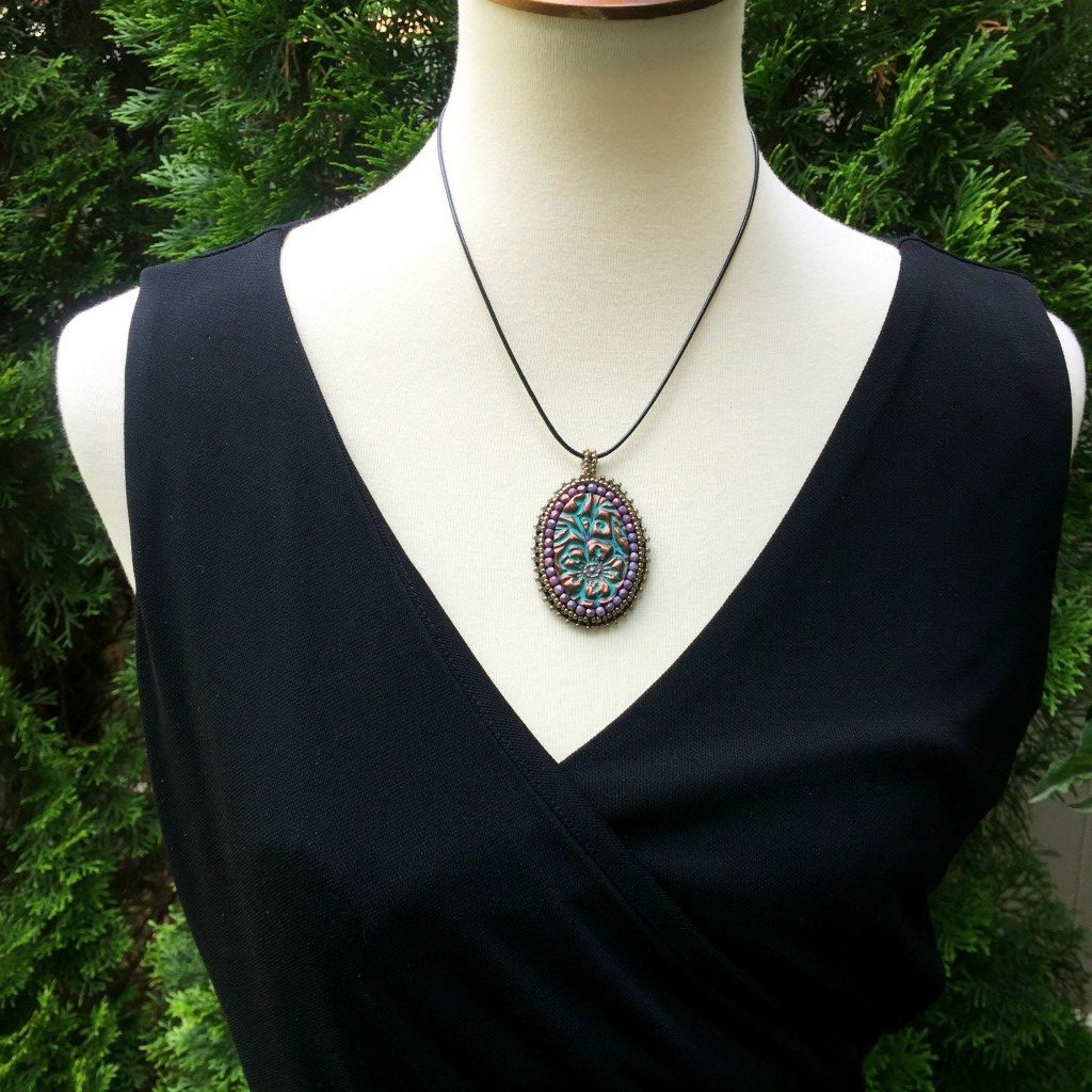 purple crystal patina necklace on mannequin