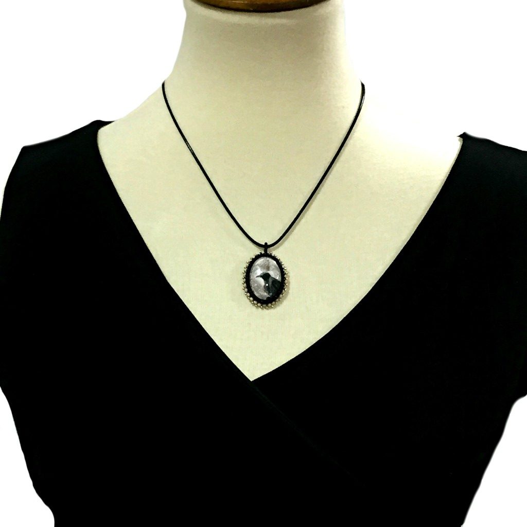 raven art necklace on mannequin