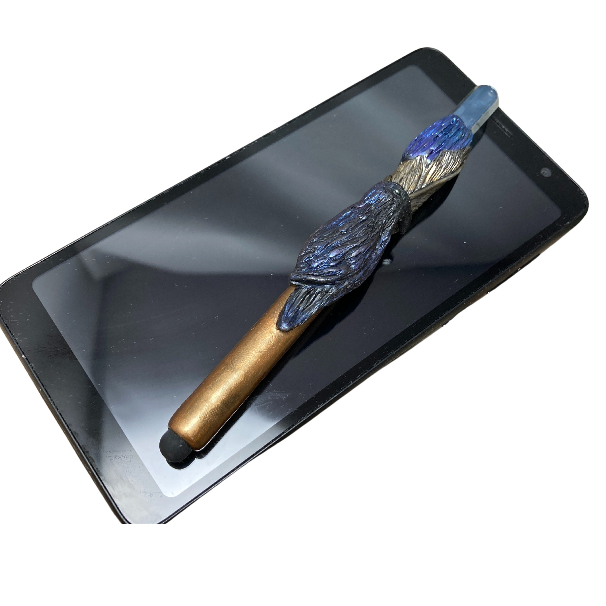 raven bird with fold feather and raw blue crystal phone stylus resting on smartphone