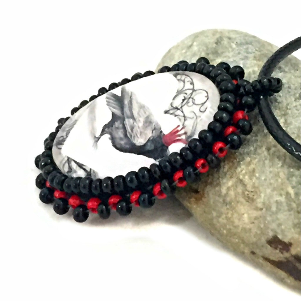 red crown raven beaded pendant