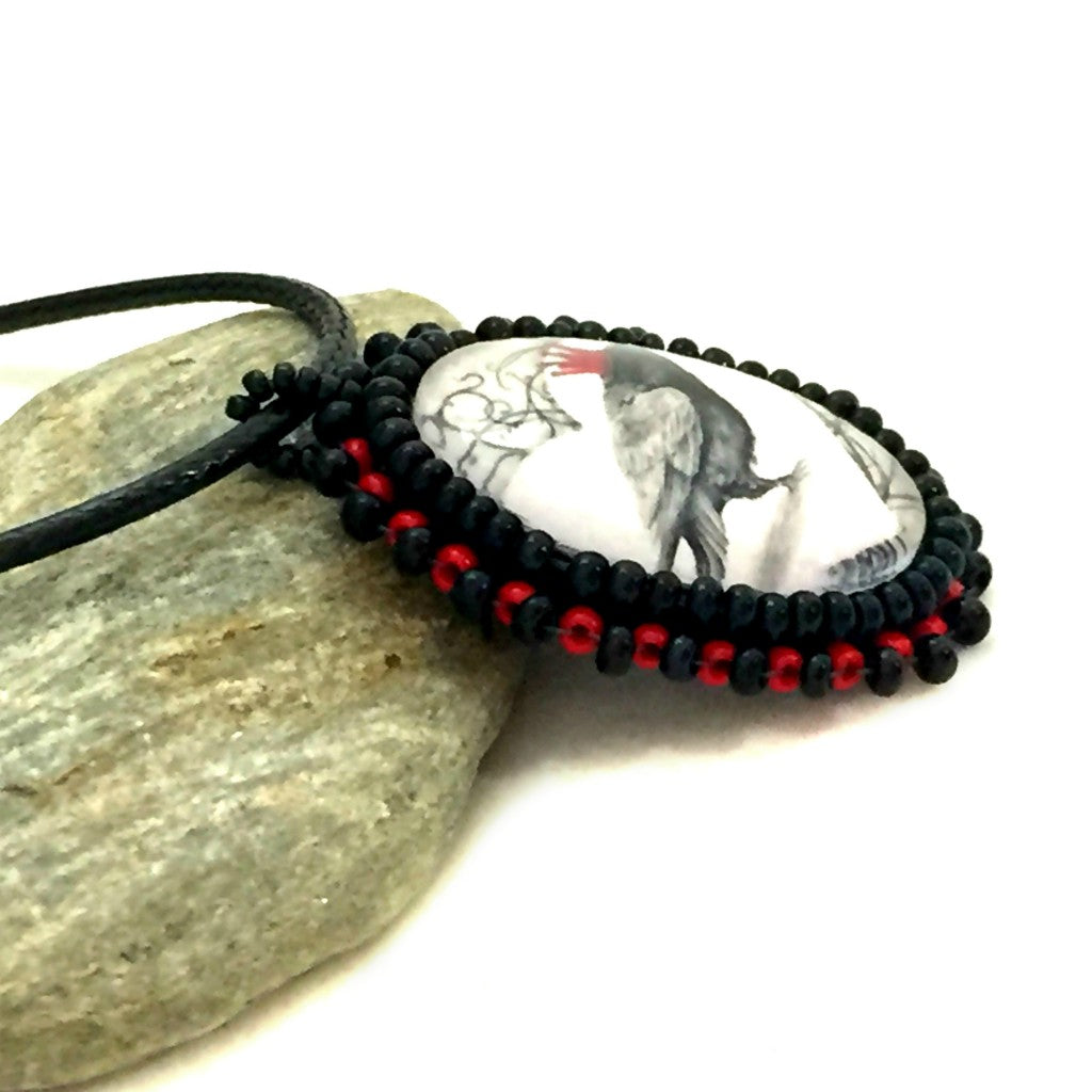 red crown raven beaded pendant