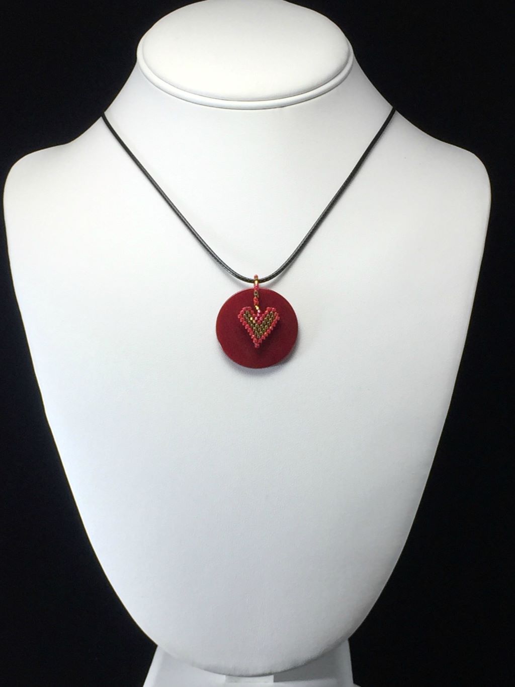 red jasper necklace with heart charm on mannequin
