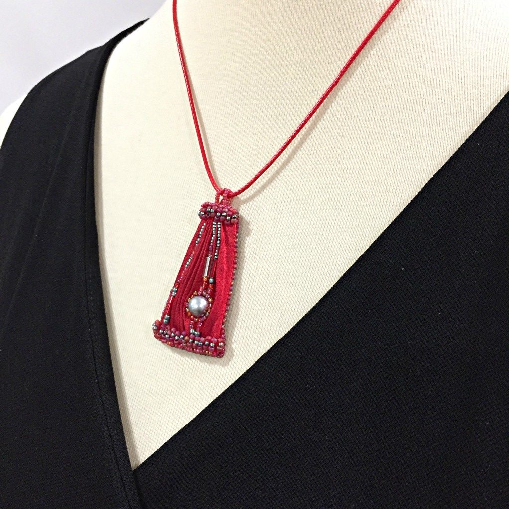 red silk pendant on mannequin