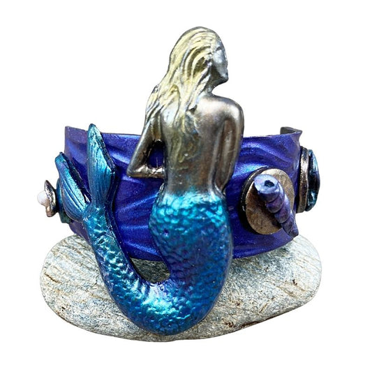 sea siren hair clip with mermaid and seashells either side of her. Hand painted blue purple and gold