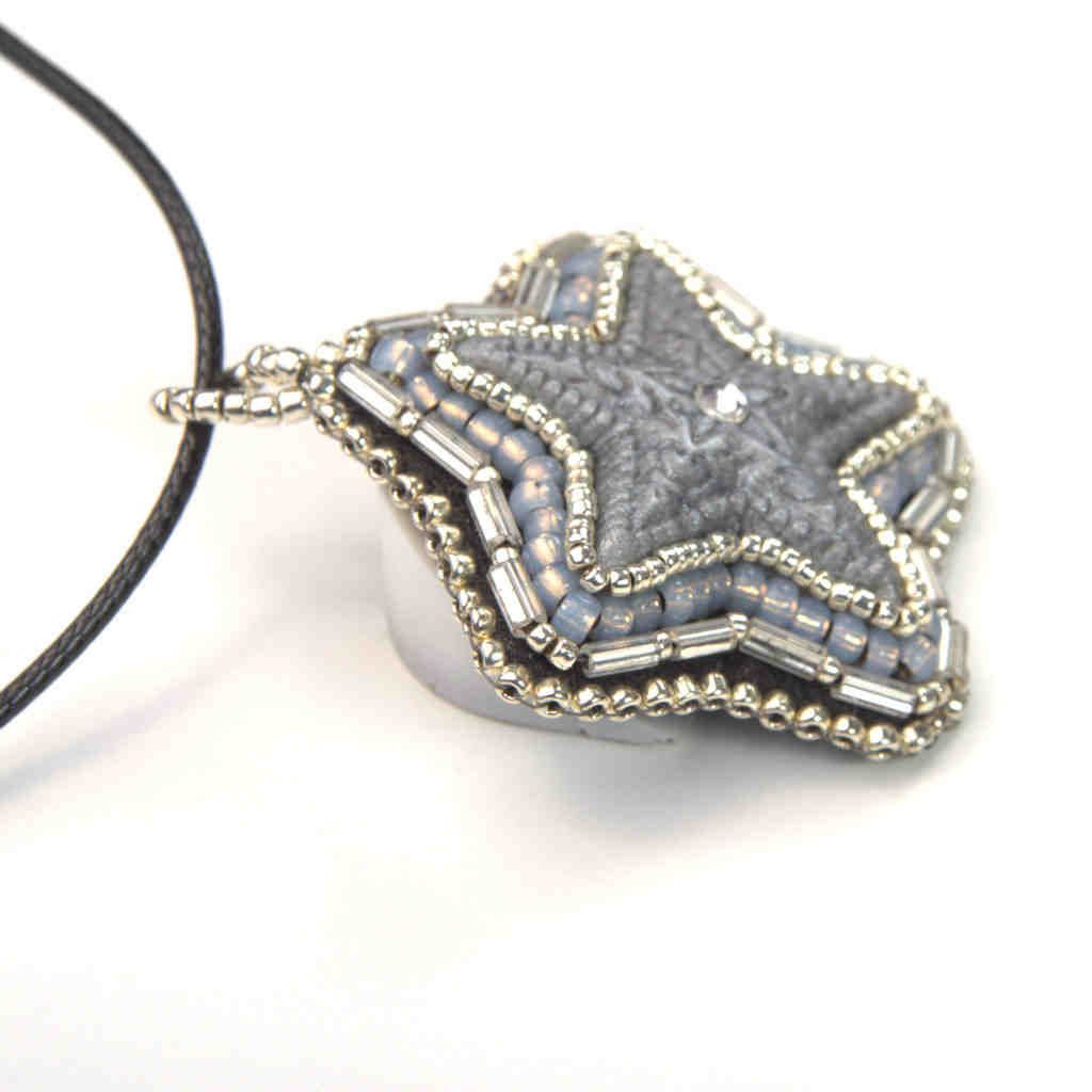 silver star pendant crystal center grey tubular beaded art