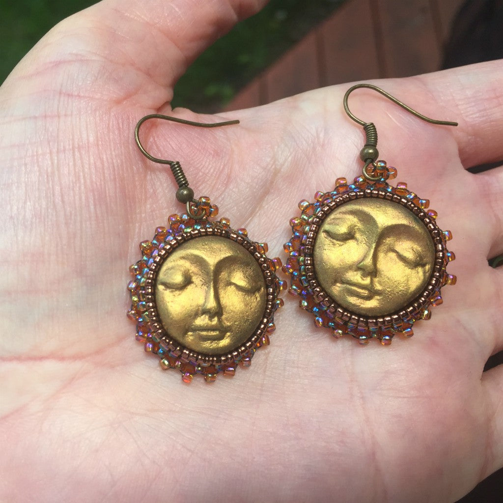 sun earrings in hand