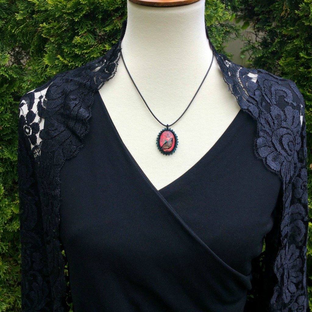 raven oval necklace with beaded edge on mannequin