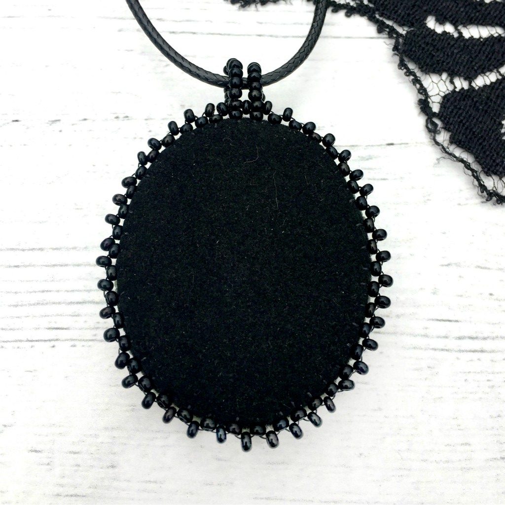 Back of turquoise raven skull pendant