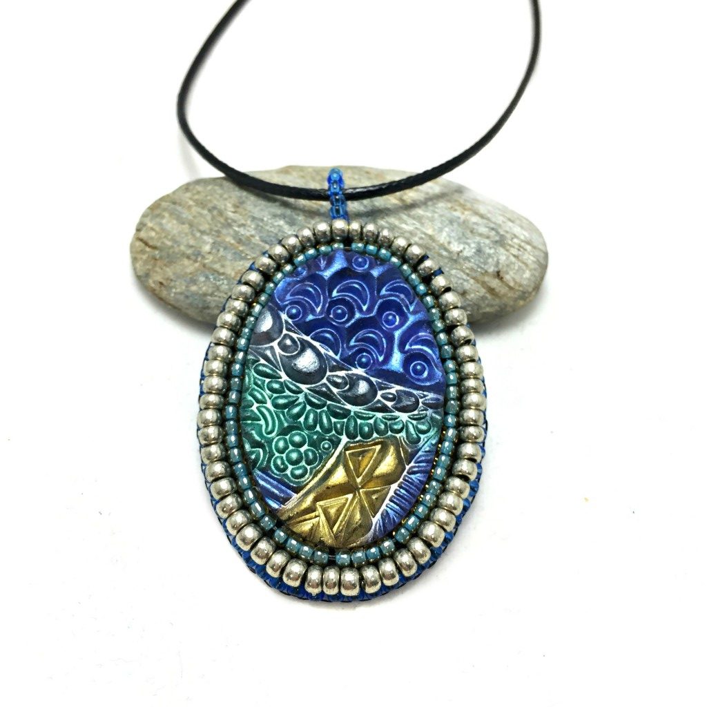 zentangle pendant with silver edge front shot